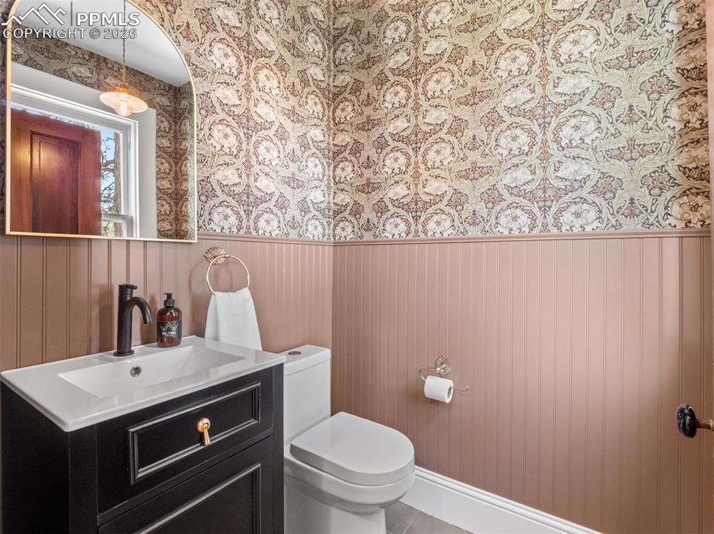 Image 6 of 41: A newly added Powder room is located on the main level near the back door.