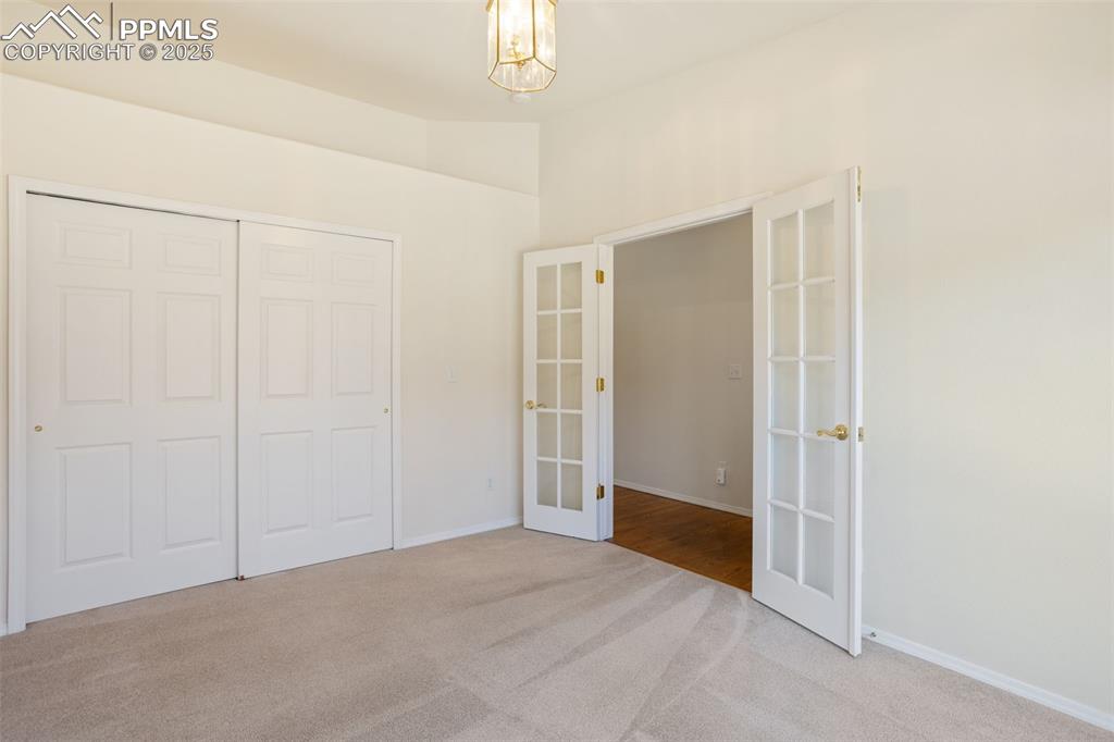Image 16 of 36: French Doors in Main Level Bedroom that Could also Serve as an Office!