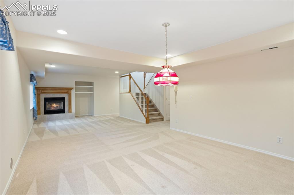 Image 18 of 36: Basement Family Room with Gas Fireplace!