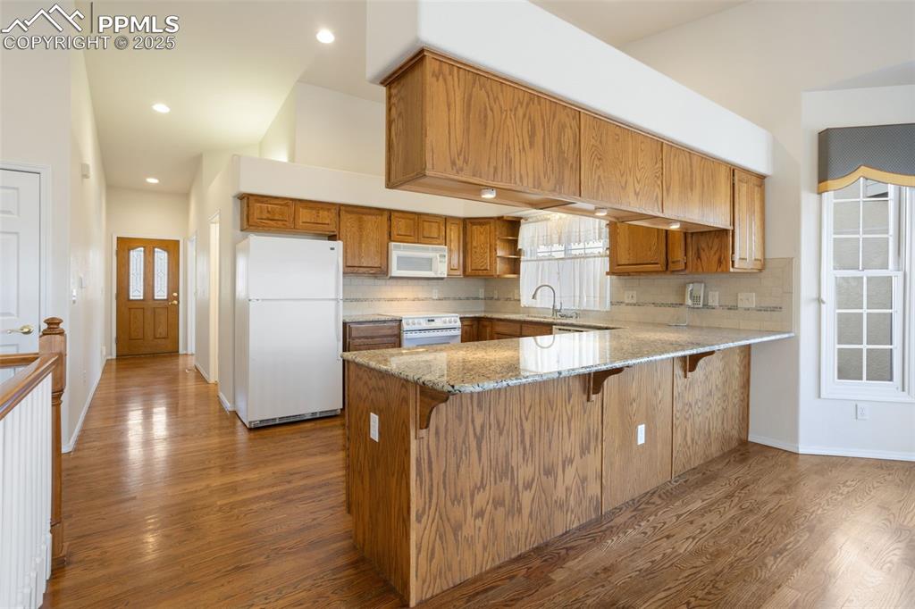 Image 4 of 36: Generously Sized Kitchen with Sprawling Granite Counter Tops!
