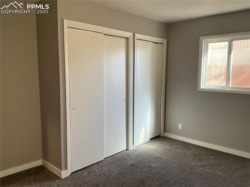 Image 17 of 43: Unfurnished bedroom featuring new carpet flooring and two closets