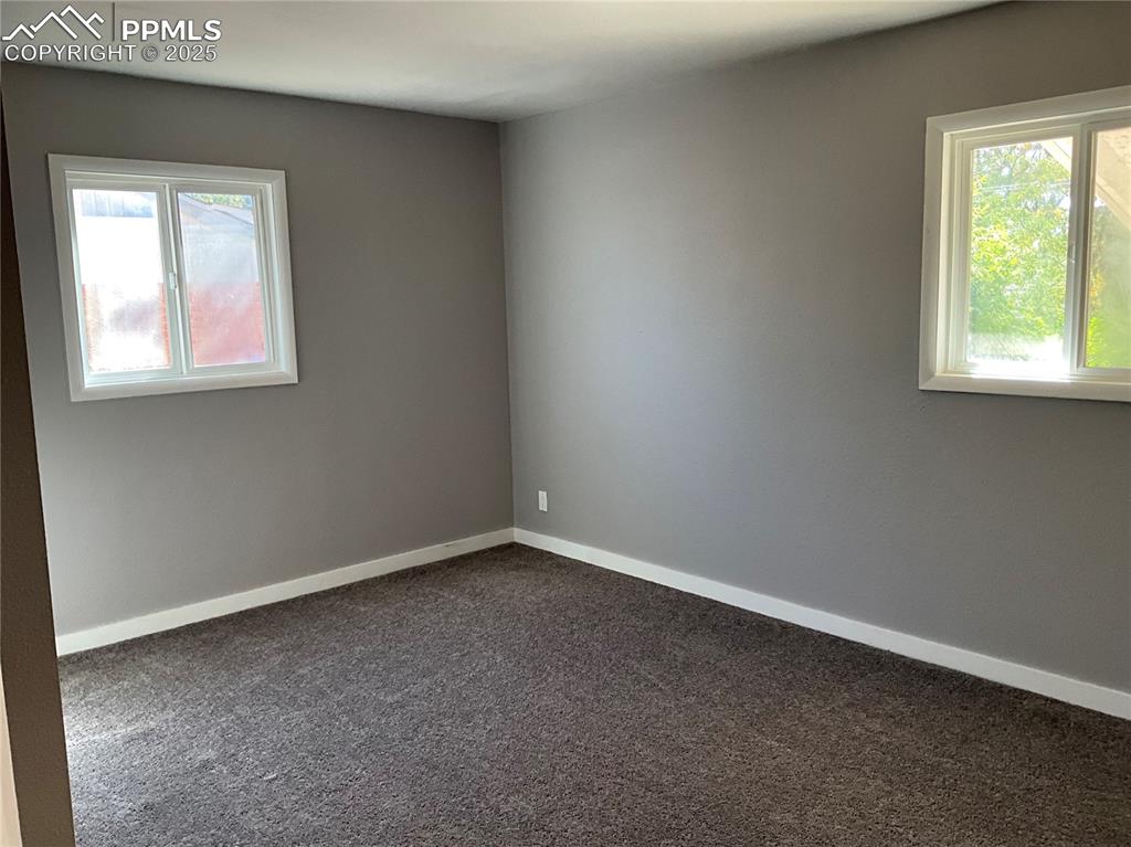 Image 18 of 43: Unfurnished room with new carpet and baseboards