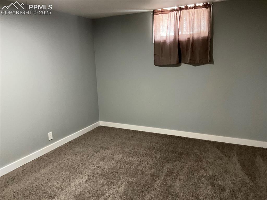 Image 24 of 41: Spare room featuring carpet floors and baseboards
