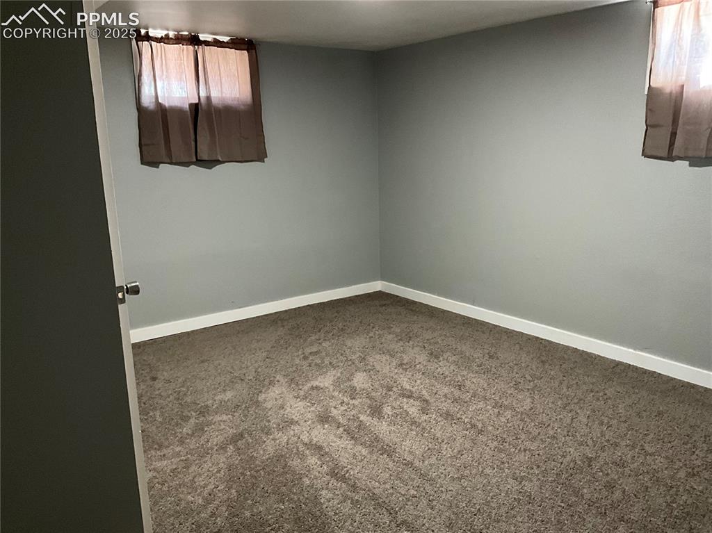 Image 26 of 41: Unfurnished room with carpet floors and baseboards