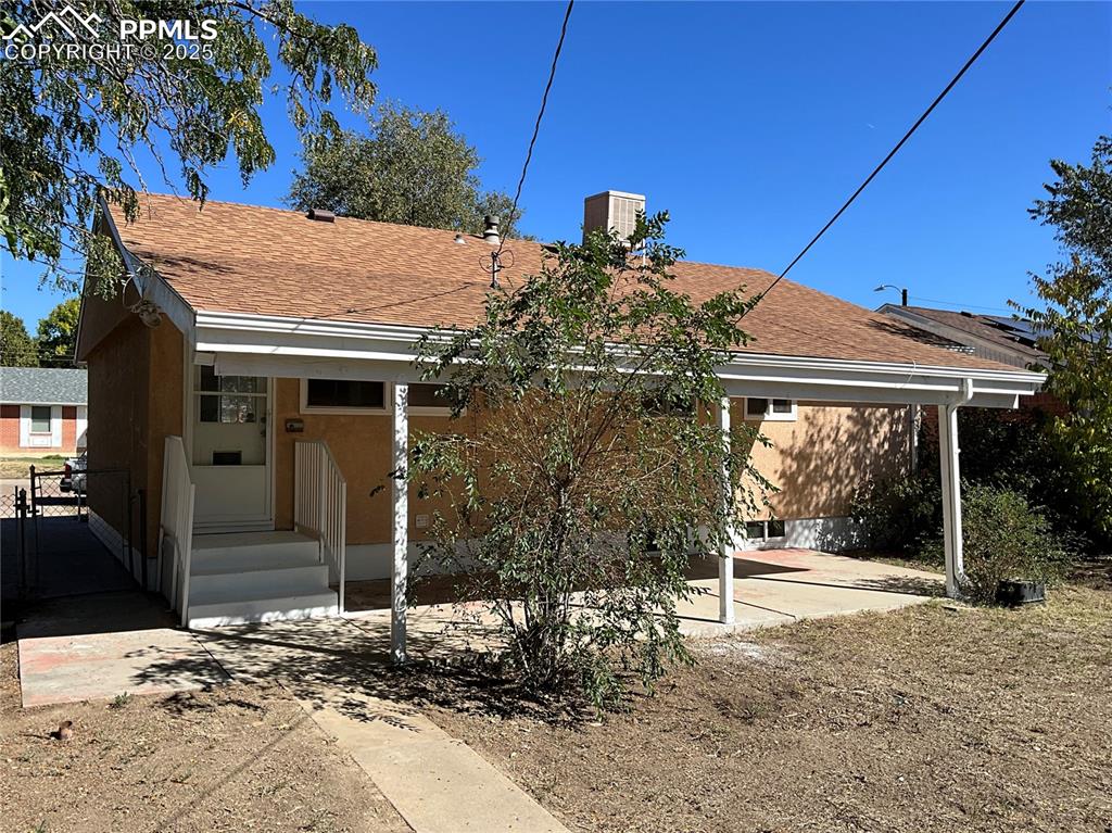 Image 3 of 43: Back of house featuring roof with shingles and stucco siding