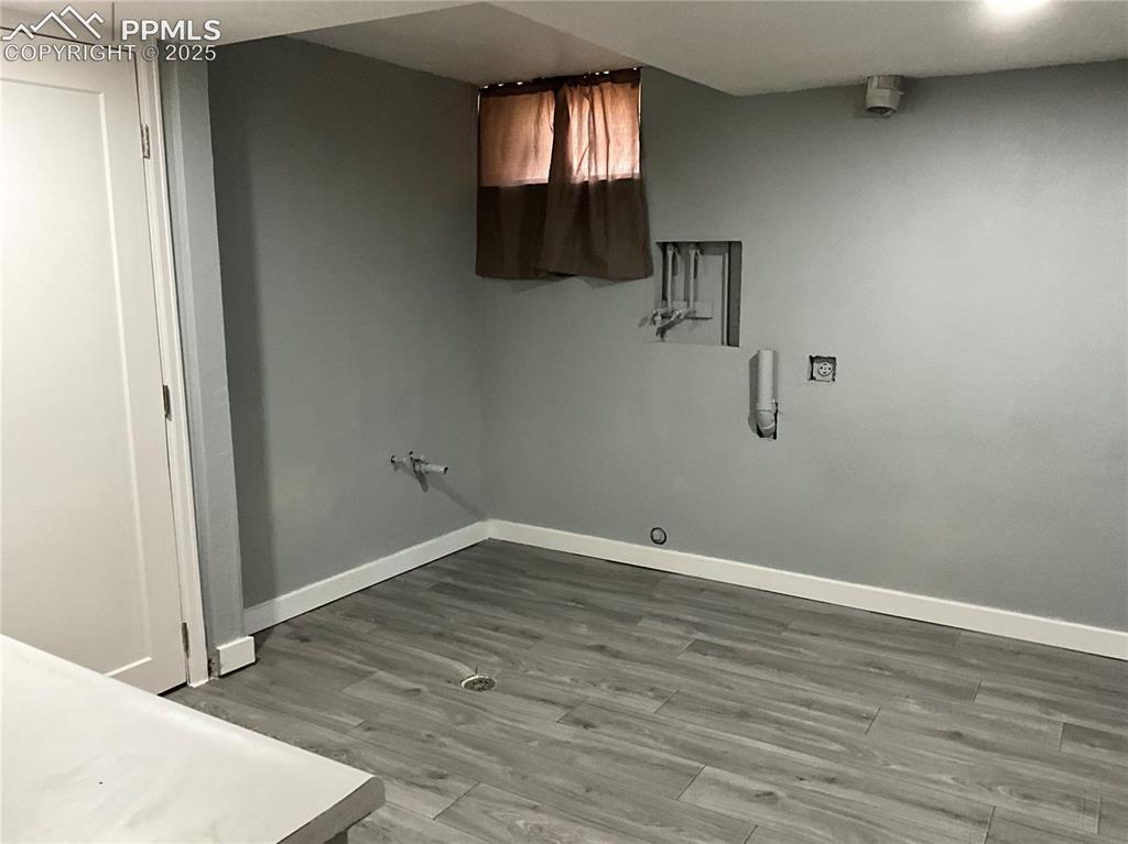 Image 31 of 41: Laundry area featuring light wood-style floors, cabinet space, and hookup f