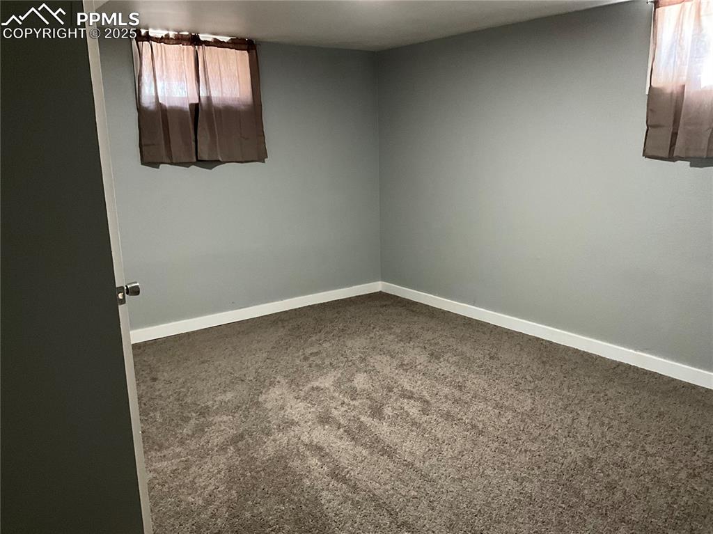Image 32 of 43: Unfurnished room with carpet floors and baseboards