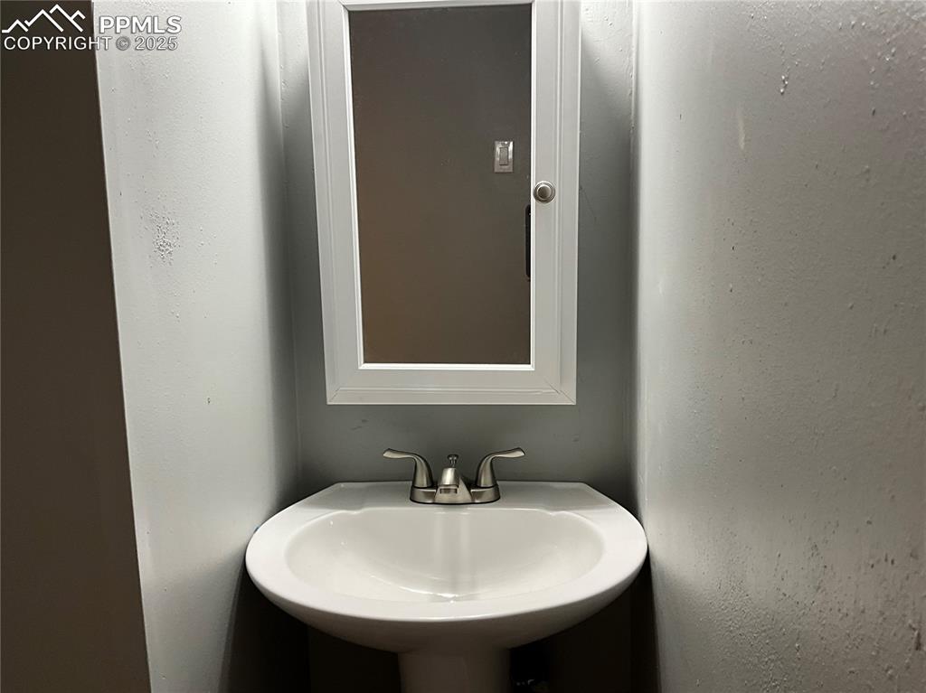 Image 34 of 43: Bathroom with a textured wall