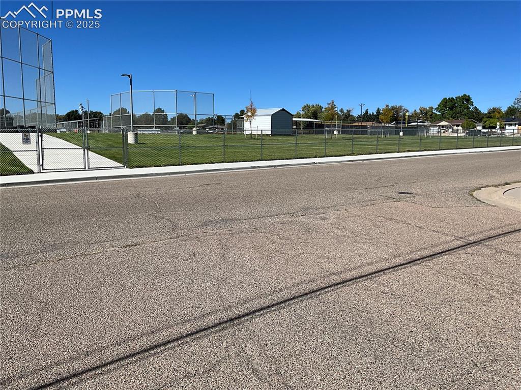 Image 35 of 41: View of asphalt road featuring sidewalks and curbs