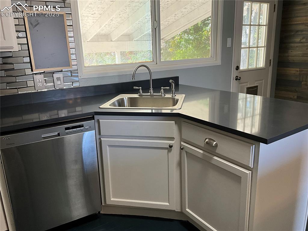 Image 7 of 43: Kitchen featuring dishwasher, healthy amount of natural light, and white ca