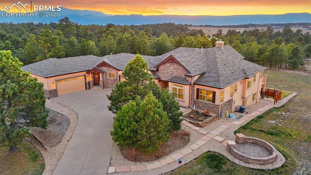 Caption: Breathtaking sunset views from luxurious ranch-style home featuring adjoining casita