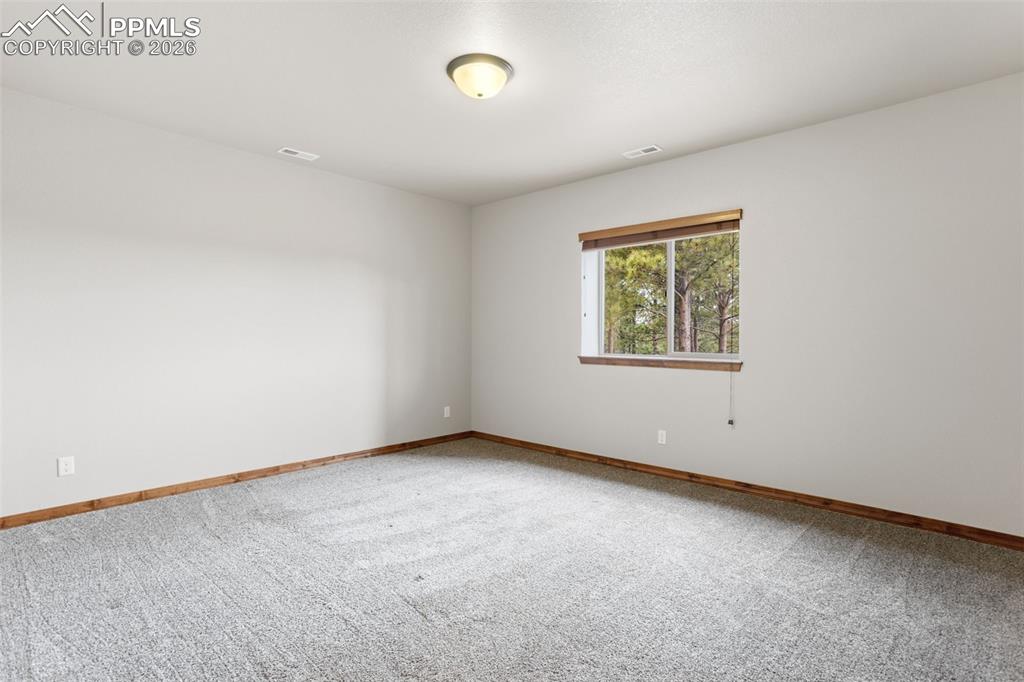 Image 41 of 49: Basement bedroom featuring a cork floor, perfect for use as a home gym