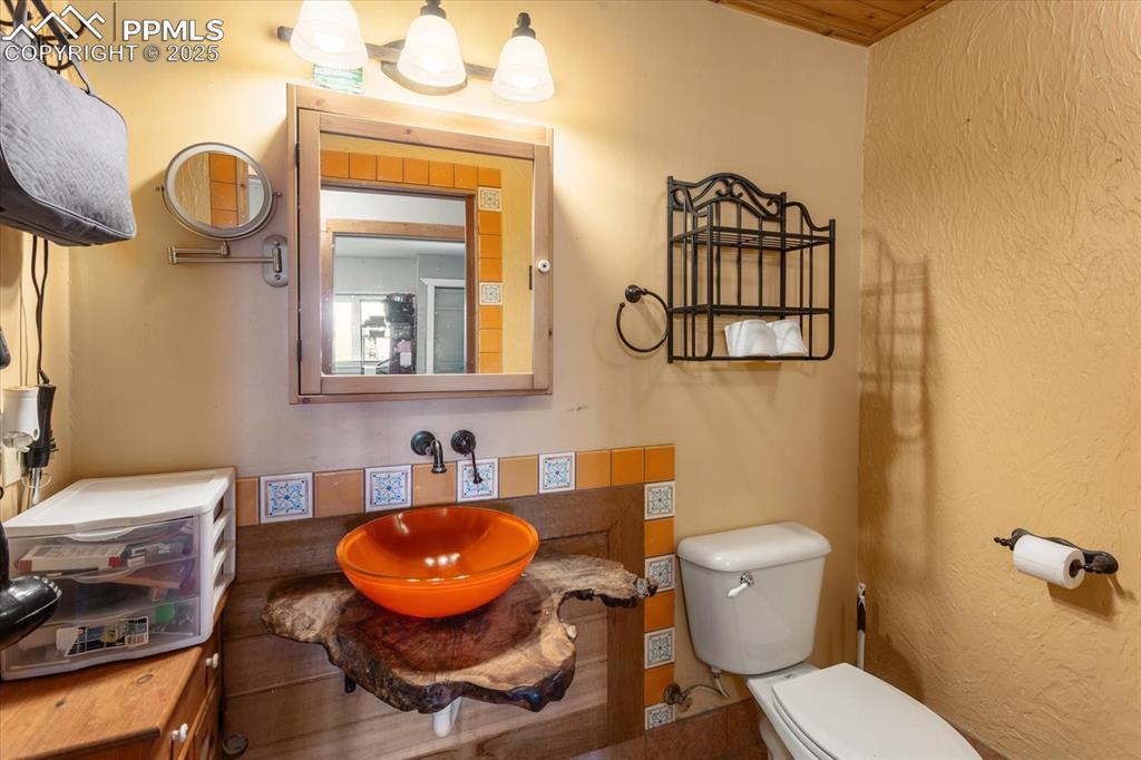 Image 18 of 45: Bathroom with toilet and a sink
