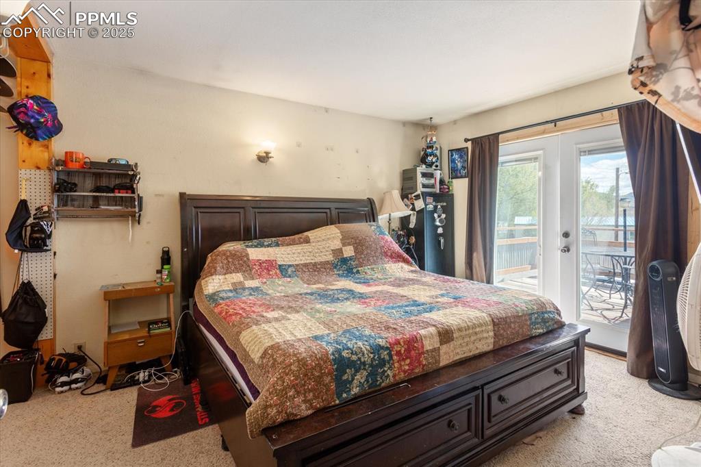 Image 20 of 45: Bedroom featuring light colored carpet and access to outside
