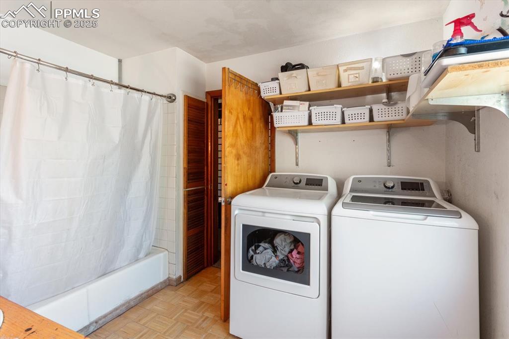 Image 31 of 45: Laundry room featuring washing machine and dryer