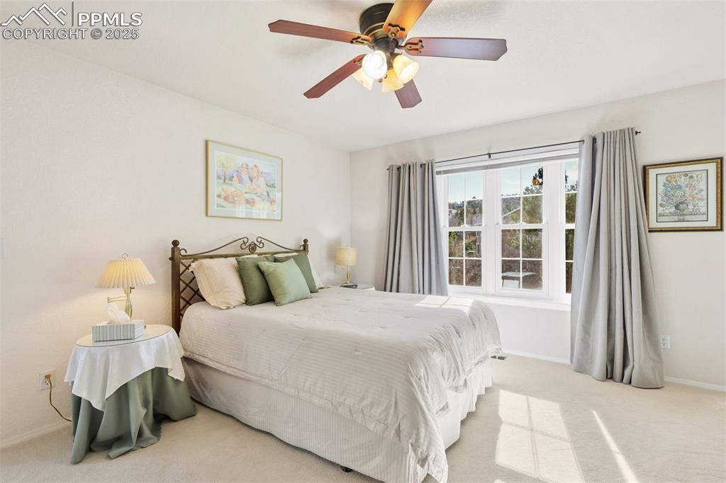 Image 17 of 49: Bedroom with carpet floors and a ceiling fan