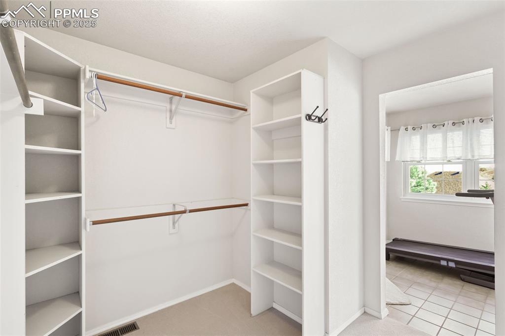 Image 21 of 49: Spacious closet featuring light colored carpet