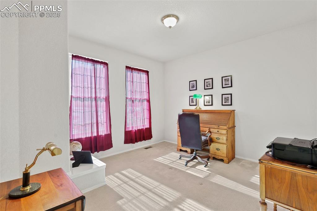 Image 29 of 49: Carpeted office space featuring baseboards