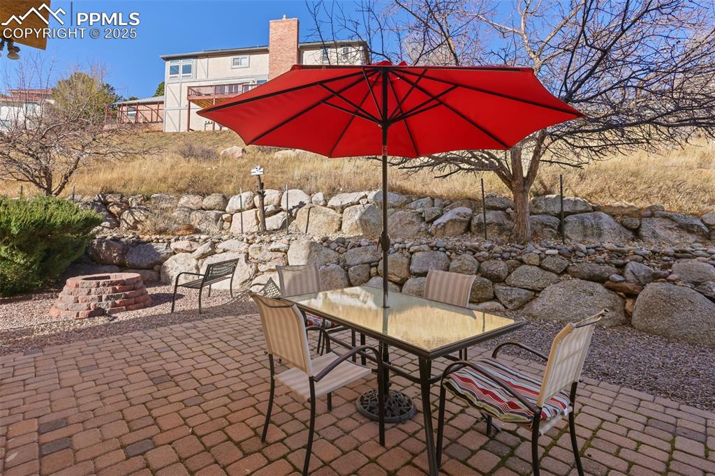 Image 34 of 49: View of patio / terrace featuring outdoor dining area and a fire pit