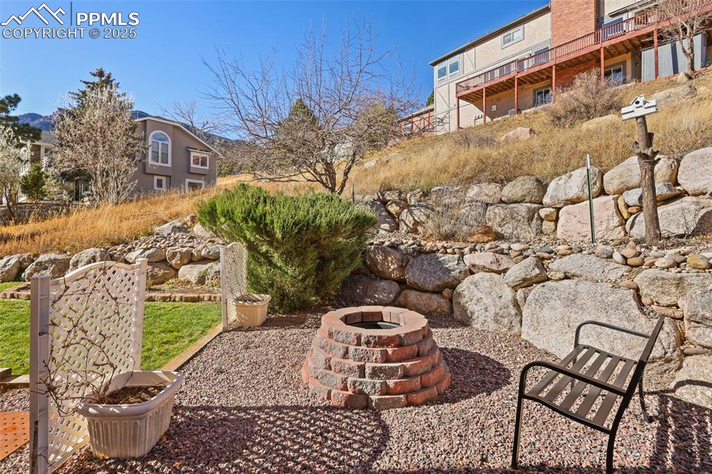 Image 36 of 49: View of patio / terrace with an outdoor fire pit