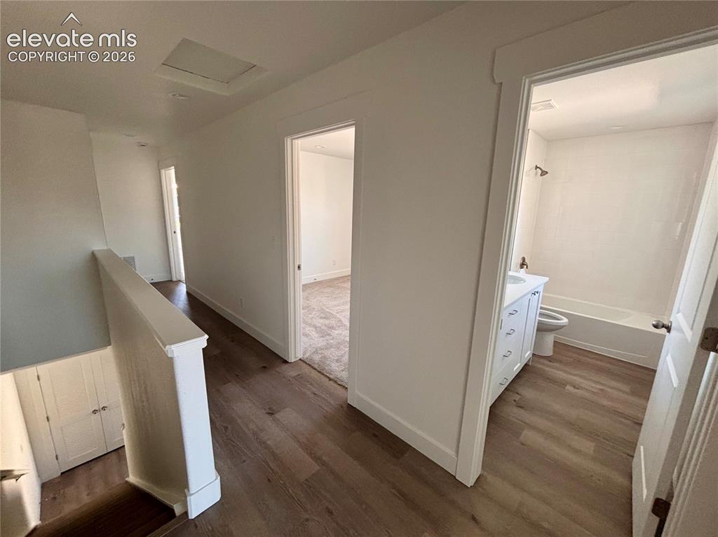 Image 11 of 23: Wood-finish flooring throughout, white painted walls, and white trim