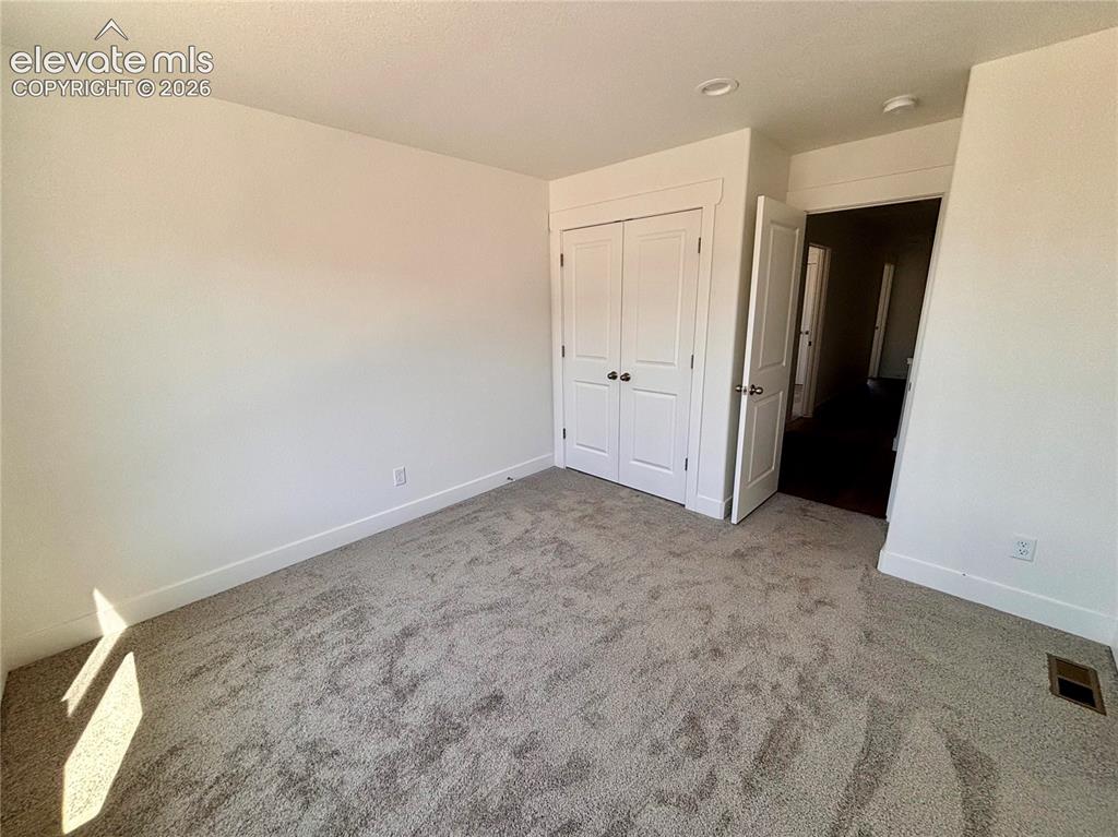 Image 12 of 23: Neutral-toned carpeting, white walls, white trim, recessed lighting, and a 
