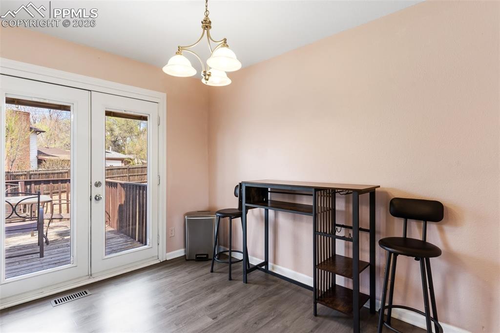 Image 13 of 35: Eat-in kitchen with walkout to wood deck