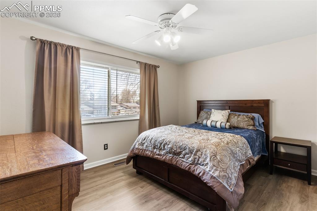 Image 15 of 35: Primary bedroom with ceiling fan