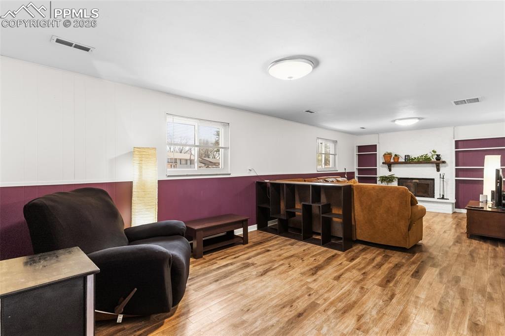 Image 20 of 35: Family room on lower level with LPV & fireplace