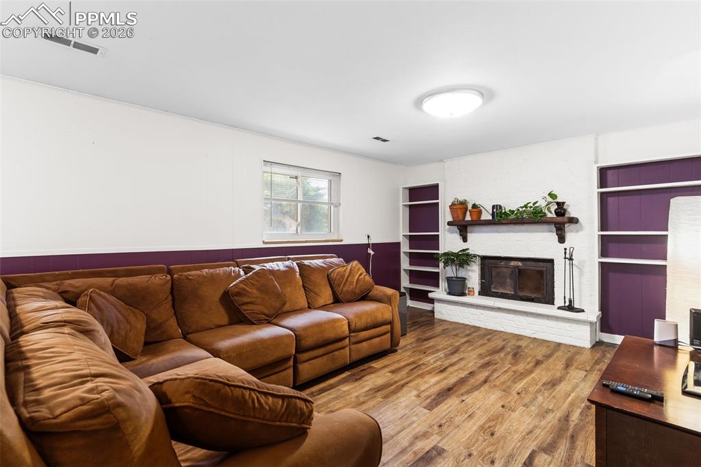Image 22 of 35: Family room featuring wood fireplace