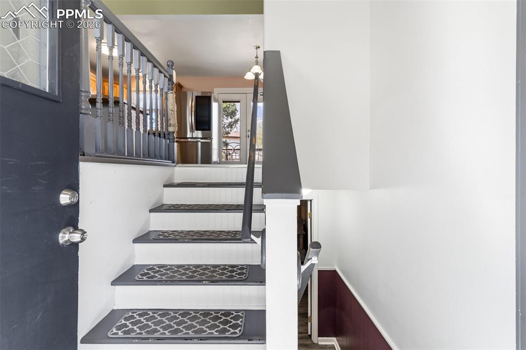 Image 4 of 35: Entry with stairs to the upper level.
