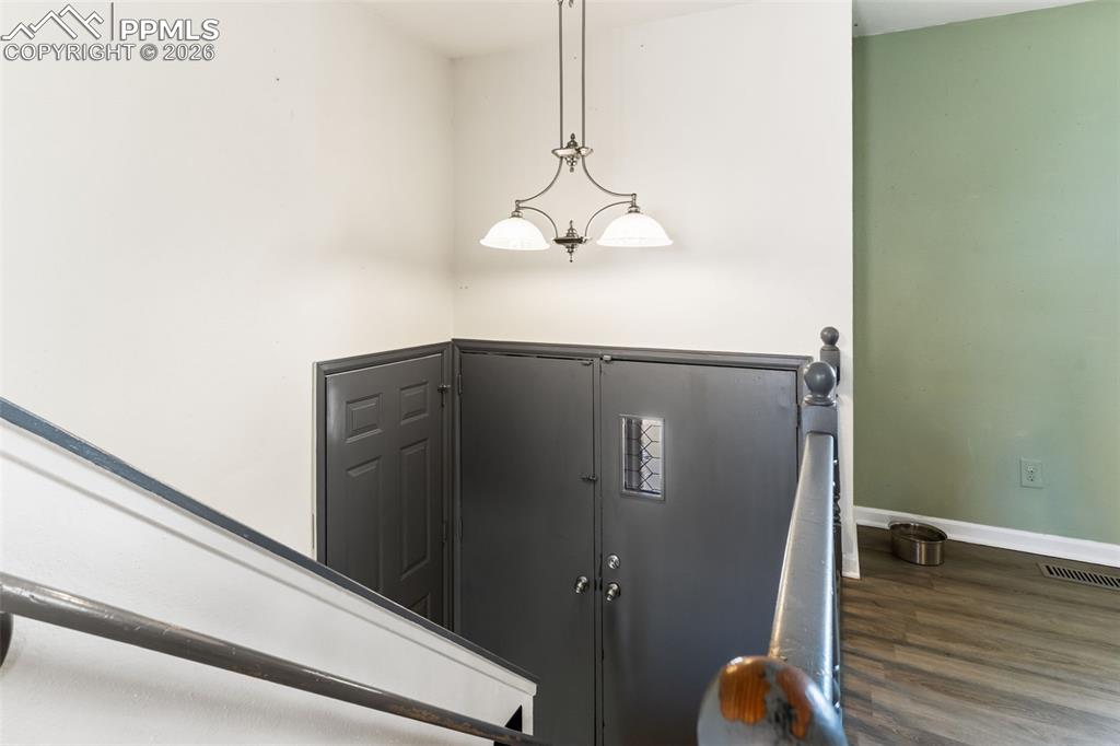 Image 5 of 35: View of front door from upper level.