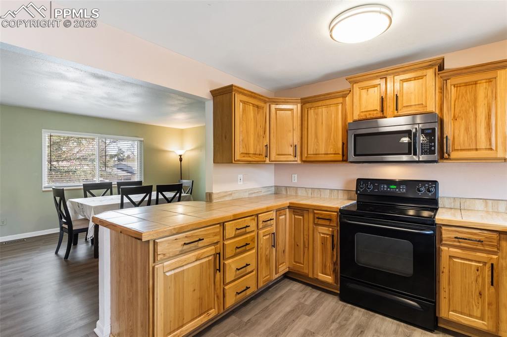 Image 9 of 35: Kitchen opens to living room