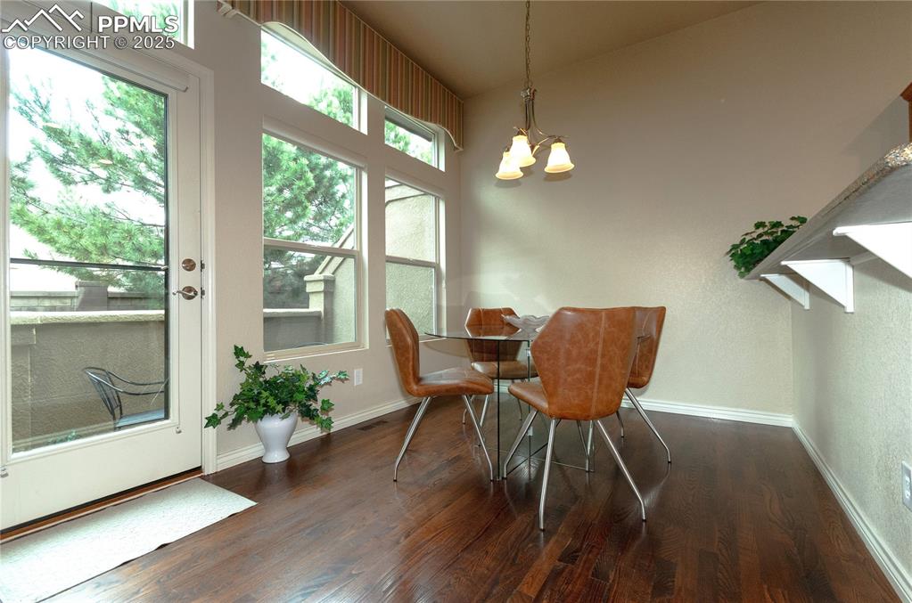Image 11 of 43: Eat-in nook with a breakfast bar and walk-out to private patio.