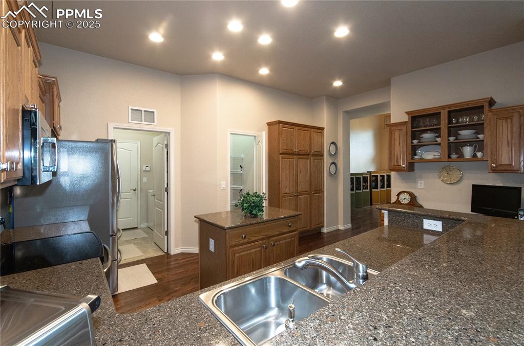 Image 13 of 43: Kitchen island for easy prepwork, pantry and wall of cabinets for additiona
