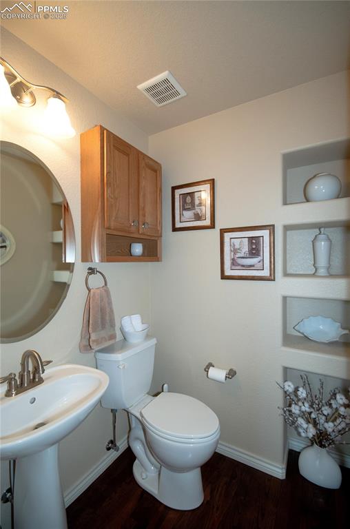 Image 19 of 43: Powder bath with pedestal sink & cabinet over the toilet.