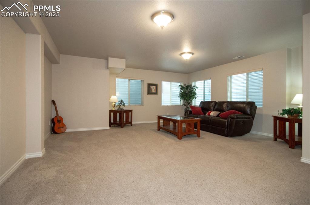 Image 27 of 43: Large family room offers space for game nights, arts and crafts, social gat