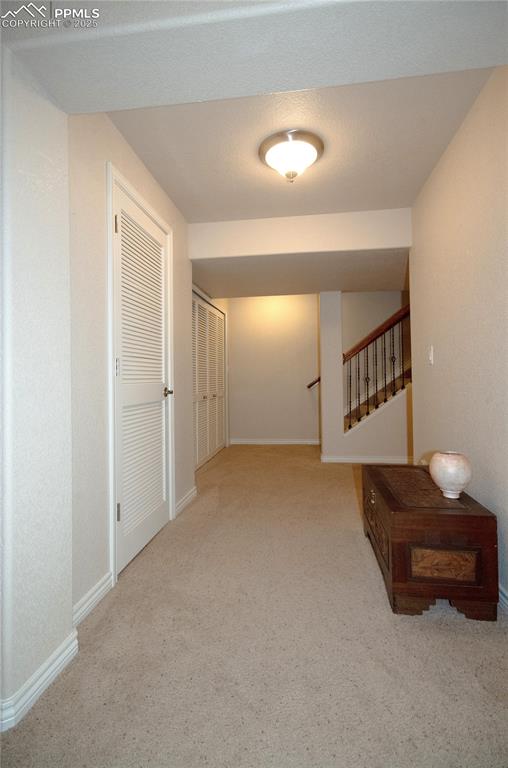 Image 30 of 43: Nice wide hallways in lower level.