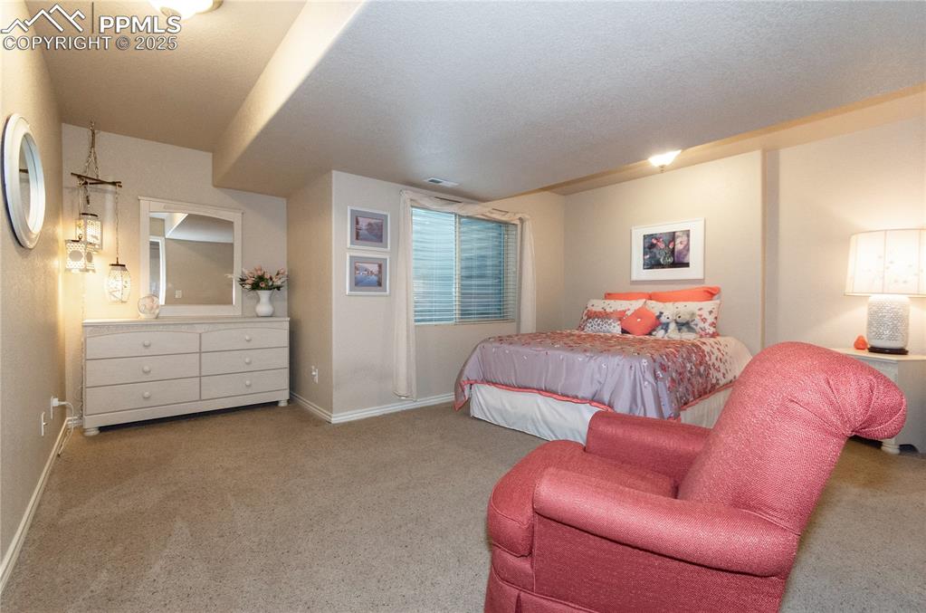 Image 31 of 43: Lower level bedroom offers a sanctuary retreat for family or guests.