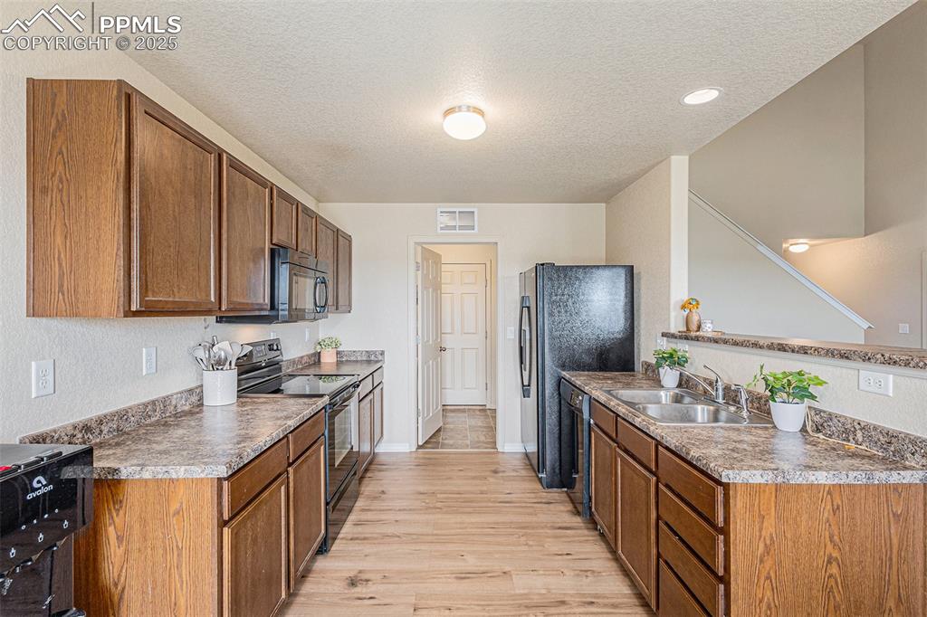 Image 11 of 36: Kitchen with Black Appliances
