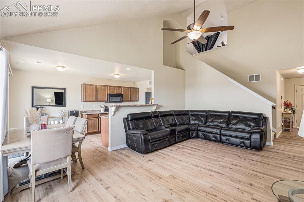 Image 8 of 36: Family Room with Lighted Ceiling Fan