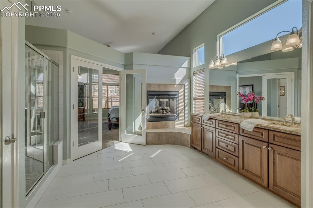 Image 18 of 50: With view of the two sided fireplace