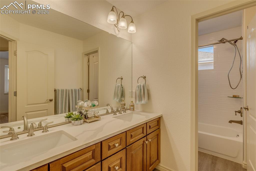 Image 29 of 50: Upper level bath with dual sinks