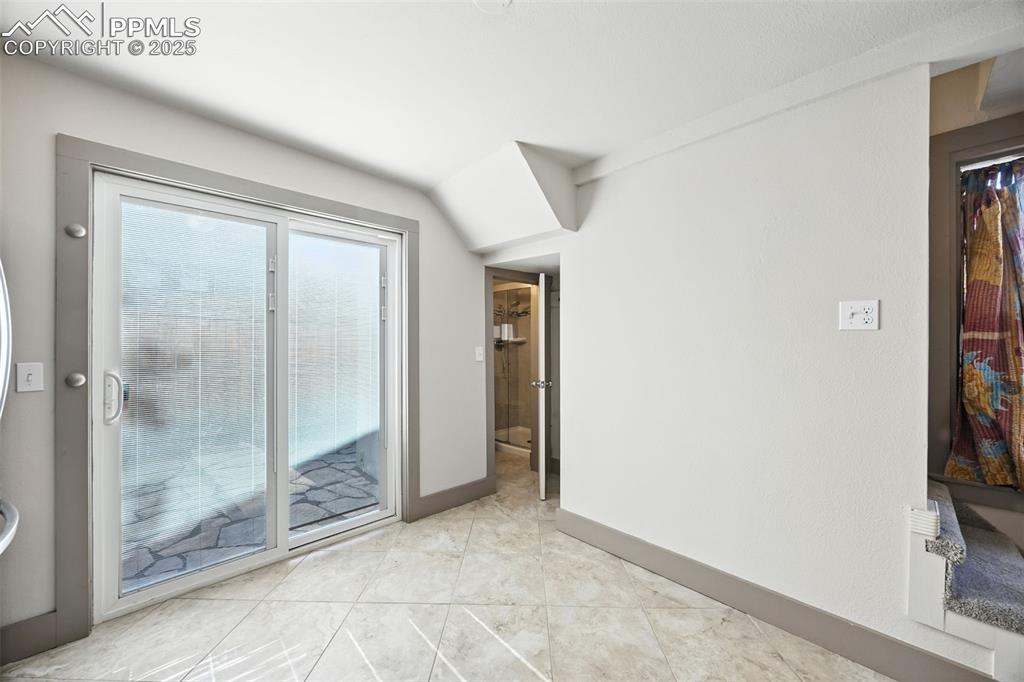 Image 17 of 25: Unfurnished room featuring light tile patterned floors and baseboards
