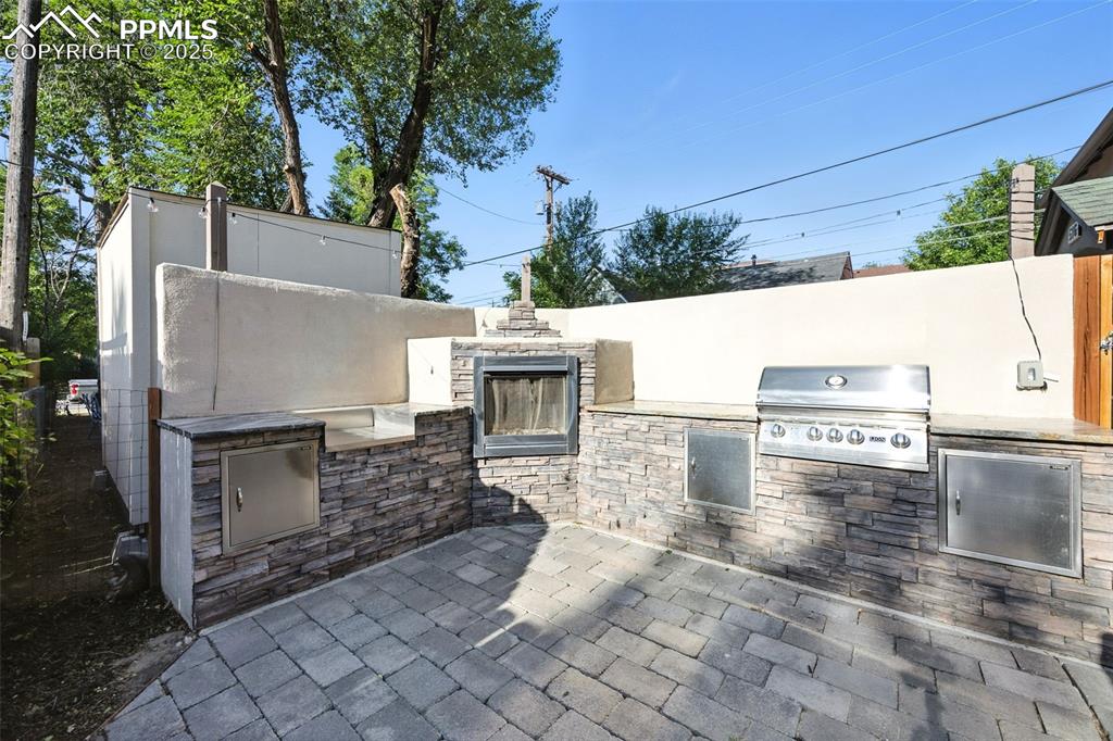 Image 5 of 25: View of patio with area for grilling