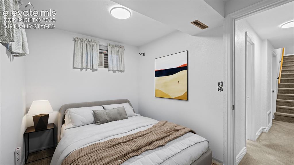Image 21 of 35: Downstairs bedroom. Virtually staged