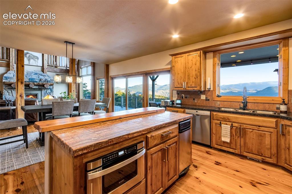 Image 22 of 50: granite tile countertops, knotty alder cabinets, crown molding, hardware, L