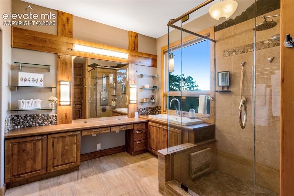 Image 29 of 50: and a spacious walk-in closet with plenty of cabinets, organizers and a ful