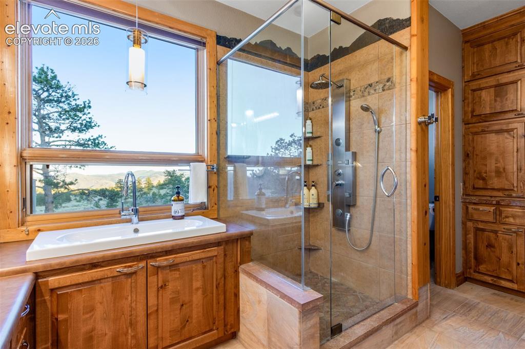 Image 30 of 50: walk-in closet, luxury private bath featuring built-in cabinetry, sandstone