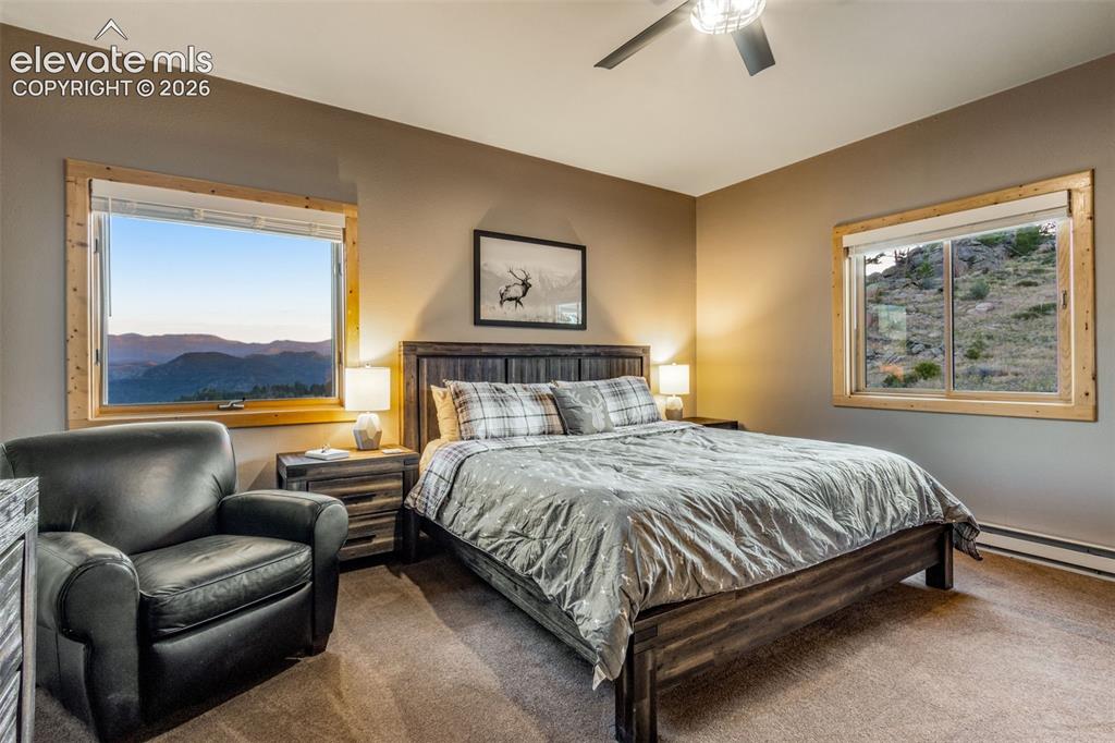 Image 34 of 50: Guest bed 2 with retreat, views, ceiling fan, attached shelving and attic a